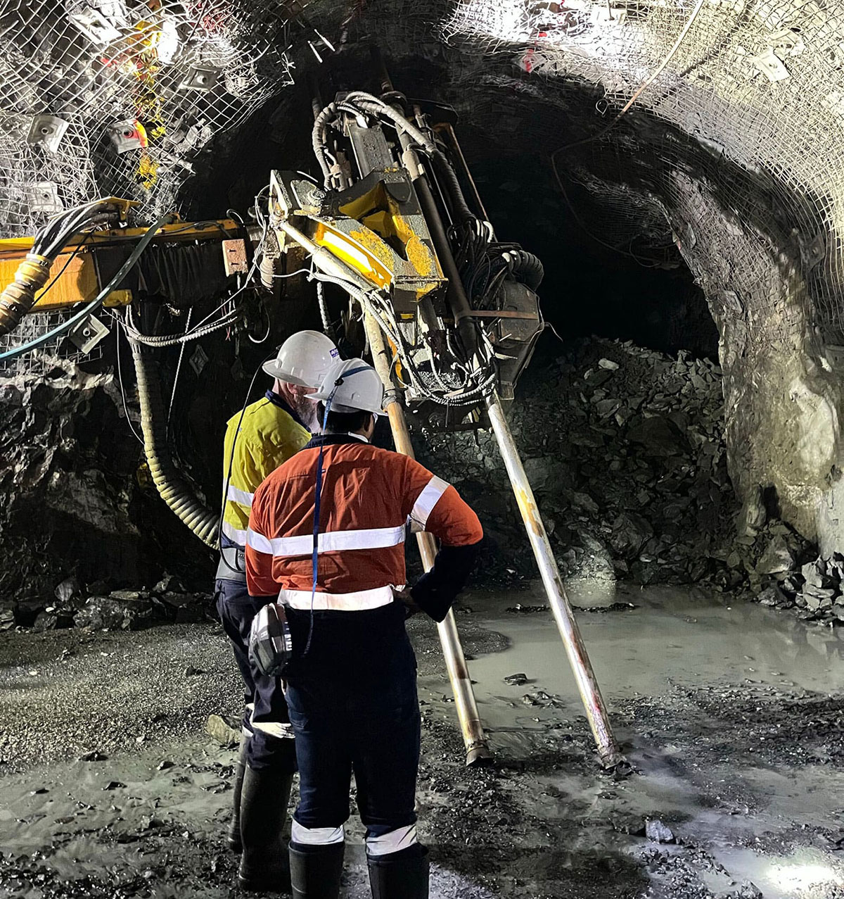 miners in high vis inside a tunnel